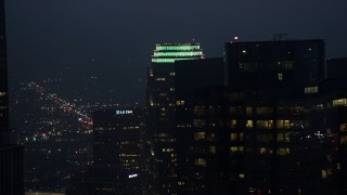 AX44_075 - 4K aerial stock footage flying by Figueroa at Wilshire skyscraper, Downtown Los Angeles, twilight