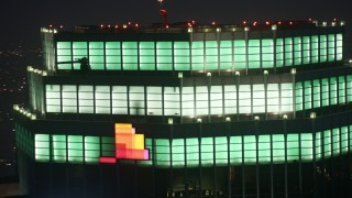 4K aerial stock footage of close-up of Figueroa at Wilshire skyscraper, Downtown Los Angeles, night Aerial Stock Footage | AX44_078