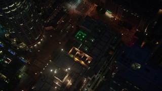 4K aerial stock footage orbiting Los Angeles Public Library and tilt down, Downtown, night Aerial Stock Footage | AX44_080