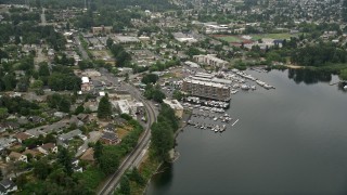 AX45_003 - 5K aerial stock footage approaching a small lakeshore marina and waterfront condo complexes, Rainier Beach, Washington