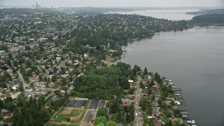 5K aerial stock footage of suburban homes near the lake, Pritchard Island Beach park, Rainier Beach, Washington Aerial Stock Footage | AX45_004