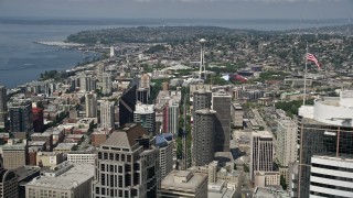 5K aerial stock footage of the Space Needle seen while flying by downtown skyscrapers, Downtown Seattle, Washington Aerial Stock Footage | AX45_052