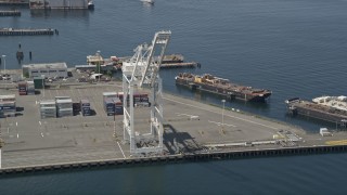 5K aerial stock footage approaching a cargo crane near shipping containers, Port of Seattle, Washington Aerial Stock Footage | AX45_094