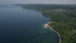 AX45_113E - 5K aerial stock footage tilt from railroad tracks on the shore of Puget Sound, Blue Ridge, Washington