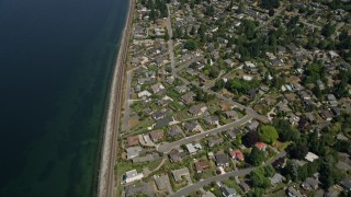 AX45_125E - 5K aerial stock footage tilt from bird's eye of railroad tracks and waterfront suburban homes, Edmonds and Lynnwood, Washington