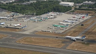 5K aerial  video fly by parked airliners at Paine Field airport, Everett, Washington Aerial Stock Footage | AX45_132