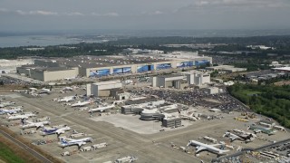 AX45_139E - 5K aerial stock footage of Boeing Everett Factory and rows of airliners at Paine Field airport, Everett, Washington