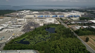 AX45_141 - 5K aerial stock footage of flying by the Boeing Everett Factory by Paine Field, Washington