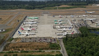 AX45_143 - 5K aerial stock footage of approaching parked airliners at Paine Field, Washington