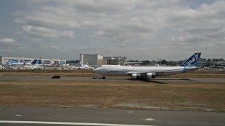 5K aerial stock footage track a 747 taxiing on a runway, Paine Field, Washington Aerial Stock Footage | AX45_148