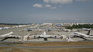 5K aerial stock footage lift off and approach parked airliners at Paine Field near Boeing Everett Factory, Washington Aerial Stock Footage | AX46_001E