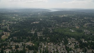 AX46_011 - 5K aerial stock footage fly over suburban neighborhoods with trees, Brier, Washington