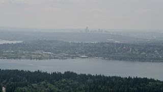 5K aerial stock footage of skyline in fog seen from tree-lined lake shores, Seattle, Washington Aerial Stock Footage | AX46_019