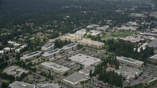 AX46_031E - 5K aerial stock footage flying by office buildings at Microsoft Headquarters campus, Redmond, Washington