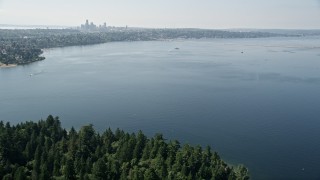 5K aerial stock footage fly over Lake Washington to approach bridge and the Downtown Seattle skyline in Washington Aerial Stock Footage | AX47_009