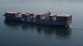 AX47_024E - 5K aerial stock footage orbit a cargo ship sailing Elliott Bay, Seattle, Washington