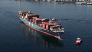 AX47_029 - 5K aerial stock footage orbit a Cargo Ships and a pair of Tugboats on Elliott Bay, Seattle