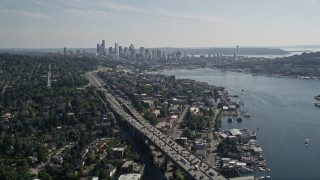 AX47_090 - 5K aerial stock footage fly over the Ship Canal Bridge to approach the Downtown Seattle skyline and Lake Union, Washington