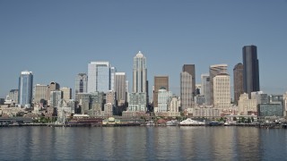 AX47_097E - 5K aerial stock footage flyby skyscrapers to reveal the Seattle Aquarium and the Seattle Great Wheel on the Central Waterfront, Downtown Seattle, Washington