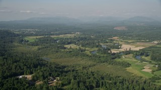 5K aerial stock footage approach the Snoqualmie River winding around farmland in Carnation, Washington Aerial Stock Footage | AX48_027