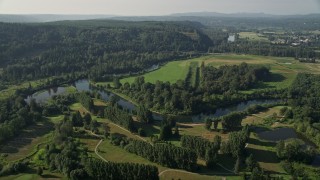 5K aerial stock footage fly over a fork in the Snoqualmie River to approach a green field in Carnation, Washington Aerial Stock Footage | AX48_029