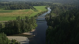 5K aerial stock footage fly over a bridge on the Snoqualmie River to approach a second bridge in Carnation, Washington Aerial Stock Footage | AX48_032E