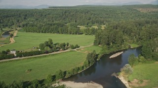 AX48_041 - 5K aerial stock footage fly over farm fields and country roads to approach forest in Fall City, Washington