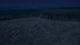 4K day for night color corrected aerial stock footage of a clear cut area, pan to approach evergreen forest in King County, Washington Aerial Stock Footage | AX48_044_DFN