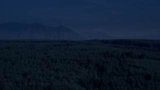 4K day for night color corrected aerial stock footage of a clear cut area, evergreen forest, and Cascade Range in King County, Washington Aerial Stock Footage | AX48_045_DFN