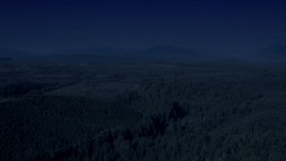 4K day for night color corrected aerial stock footage of a vast evergreen forest, and approach a clear cut area in King County, Washington Aerial Stock Footage | AX48_046_DFN