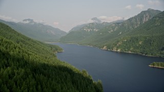 AX48_059 - 5K aerial stock footage fly over evergreen trees on mountain slope next to the South Fork Tolt Reservoir, Cascade Range, Washington