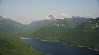 AX48_061 - 5K aerial stock footage of wooded mountain peaks beside the South Fork Tolt Reservoir, Cascade Range, Washington