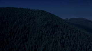 4K day for night color corrected aerial stock footage of evergreen trees covering a mountain ridge in the Cascade Range, Washington Aerial Stock Footage | AX48_062_DFN