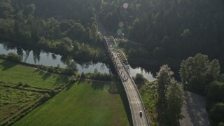 5K aerial stock footage of tracking a truck crossing a bridge spanning the Snoqualmie River, Carnation, Washington Aerial Stock Footage | AX49_020