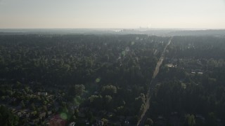 5K aerial stock footage of flying over a suburban neighborhood crowded with trees toward Downtown Bellevue, Washington Aerial Stock Footage | AX49_033