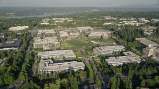 AX49_039E - 5K aerial stock footage orbit Microsoft Headquarters office buildings around The Commons soccer field, Redmond, Washington