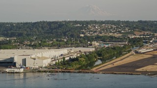 AX49_102 - 5K aerial stock footage approach the Boeing Factory from Lake Washington in Renton, Washington