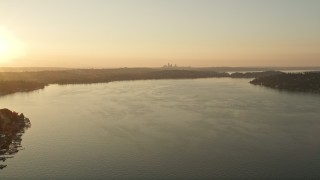 5K aerial stock footage of flying over Lake Washington with the Downtown Seattle skyline in the distance, sunset Aerial Stock Footage | AX50_002