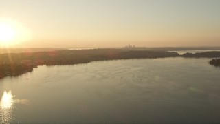 5K aerial stock footage fly over Lake Washington toward the distant Downtown Seattle skyline in the distance, sunset Aerial Stock Footage | AX50_003