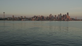 AX50_018E - 5K aerial stock footage tilt from Elliott Bay to reveal the Seattle Space Needle and Downtown Seattle skyline, Washington, sunset