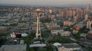 AX50_020E - 5K aerial stock footage fly over the shore of Elliott Bay to approach and orbit the Space Needle in Downtown Seattle, Washington, sunset