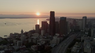 5K aerial stock footage orbit Downtown Seattle skyscrapers at sunset in Washington, with Elliott Bay in the background Aerial Stock Footage | AX50_025