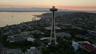 5K aerial stock footage fly over city buildings to approach and orbit KeyArena and the Space Needle at sunset, Downtown Seattle, Washington Aerial Stock Footage | AX50_031E