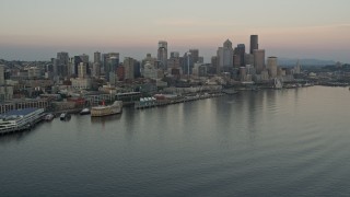 5K aerial stock footage orbit the Space Needle, skyscrapers, and Central Waterfront piers in Downtown Seattle, Washington, sunset Aerial Stock Footage | AX50_034