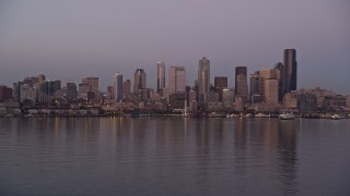 5K aerial stock footage of a view across Elliott Bay at the Downtown Seattle skyline and Central Waterfront, Washington, sunset Aerial Stock Footage | AX50_072