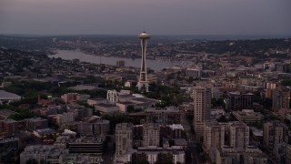 5K aerial stock footage tilt from Elliott Bay to reveal the Seattle Space Needle and Central Waterfront piers in Downtown Seattle, Washington, sunset Aerial Stock Footage | AX50_073E