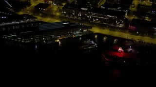 5K aerial stock footage of Pier 69 and the Edgewater Hotel at Central Waterfront, Downtown Seattle, Washington, night Aerial Stock Footage | AX51_023