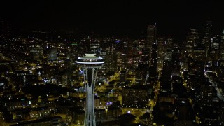 AX51_030 - 5K aerial stock footage orbit the Space Needle and reveal Downtown Seattle skyscrapers in Washington at night