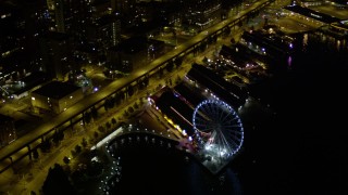 5K aerial stock footage flyby Downtown Seattle skyscrapers to reveal and orbit the Seattle Great Wheel at night, Washington Aerial Stock Footage | AX51_039E