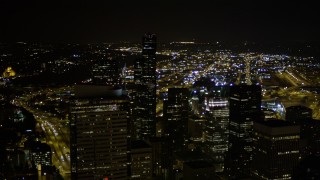 AX51_080E - 5K aerial stock footage orbit Two Union Square in Downtown Seattle, Washington, at night